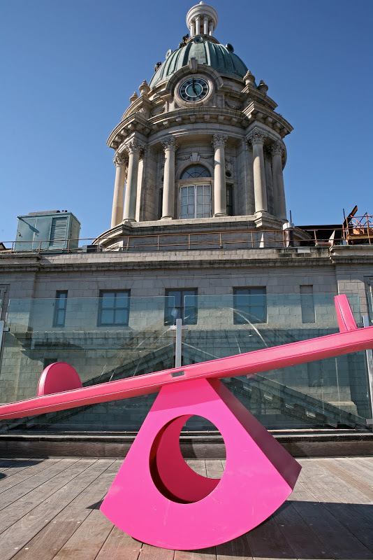 Modern hot pink seesaw on a New York City home's roof deck