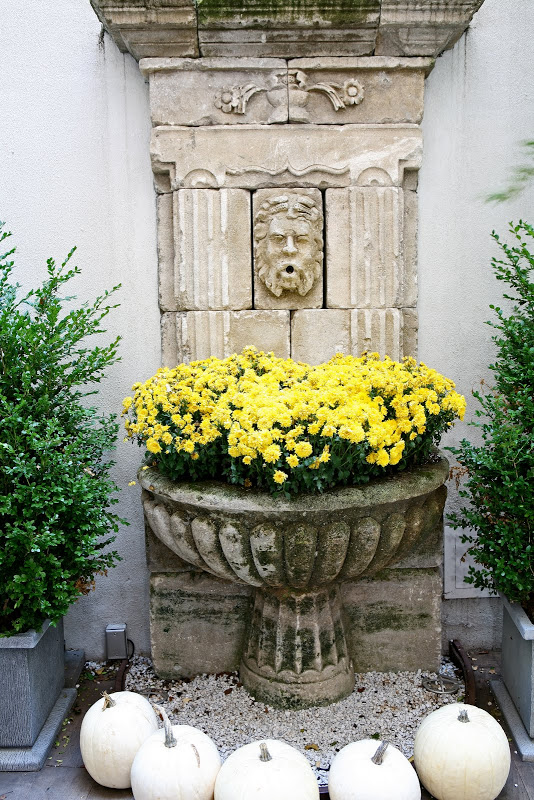 Stone fountain on an outdoor patio at the New York City Townhouse by Sixx Design