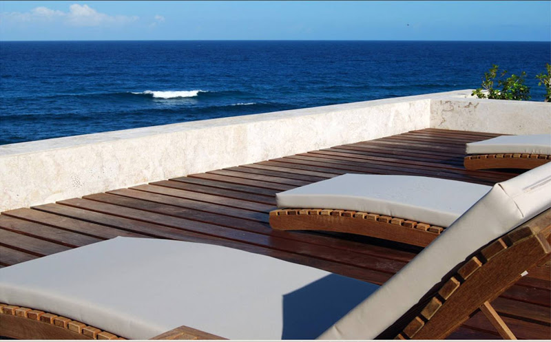 Outdoor patio with an ocean view and lounge chairs at Casa Kimball in the Dominican Republic