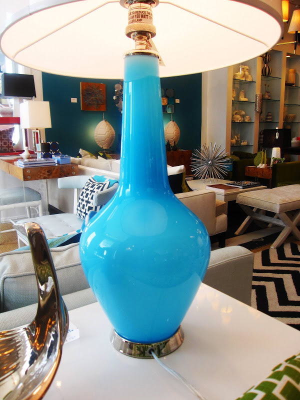 Jonathan Adler Capri Bottle lamp with a blue colored glass base with polished nickel accents