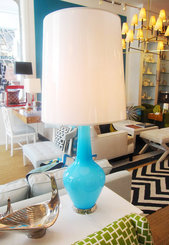 Jonathan Adler Capri Bottle lamp with a blue colored glass base with polished nickel accents