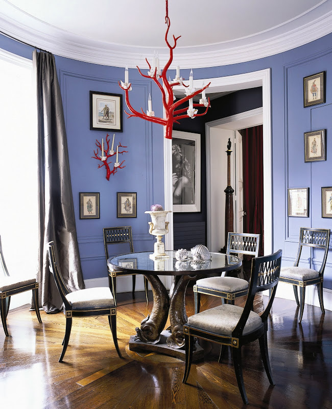Jamie Creel and Marco Scarani’s round periwinkle-blue dining room in Paris, Thomas Boog’s cast-iron Coral chandelier over a vintage Serge Roche table