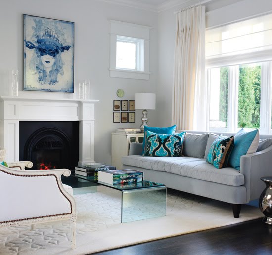 Modern meets traditional in a light airy living room with white fireplace and light blue sofa