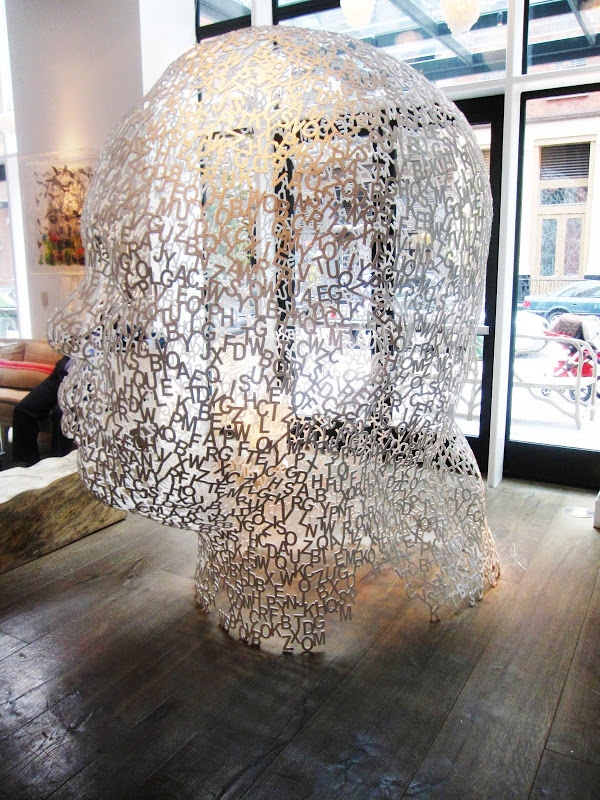 Large steel sculpture of a head made of letters by Jaume Plensa in the Crosby Street Hotel
