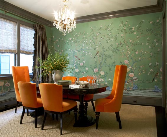 Formal dining room with green wallpaper and orange upholstered chairs