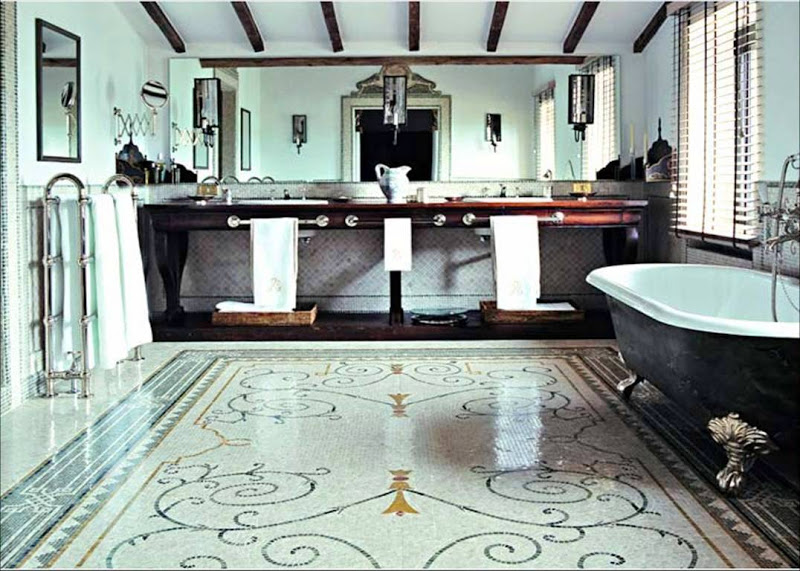 Bathroom in an Italian farmhouse with mosaic tile floor and a claw foot tub