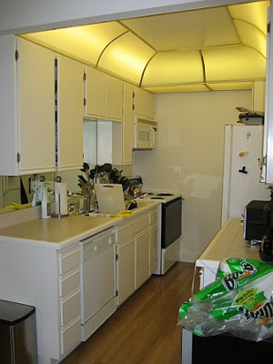 Kitchen before remodeling with white cabinets and counter tops