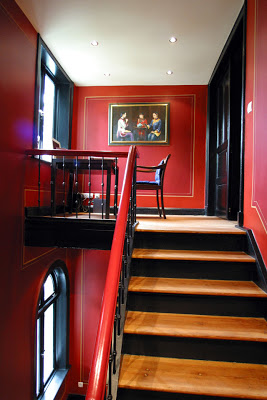 Red staircase leading up to a red landing 
