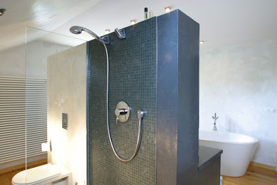 Ultra modern spa like bathroom with stand alone tub and tile shower with glass walls