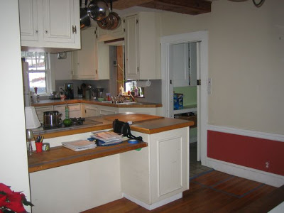 Kitchen before remodeling with 1980s cabinets and outdated appliances