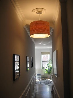 Entry hall after remodeling with crown molding, ceiling medallion, decorative molding on the walls and a drum chandelier