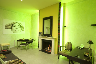 Built in mood lighting surrounds a fireplace in a London flat