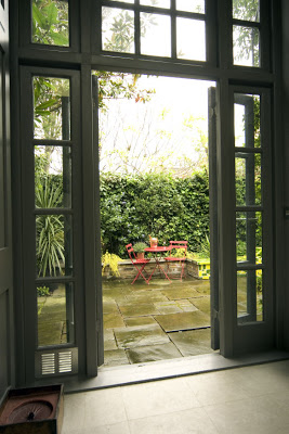French doors lead to a lush city garden in London