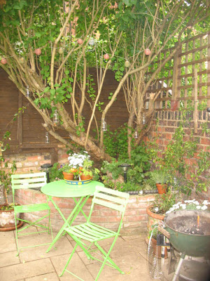 Green bistro table and chairs outside a Heath flat