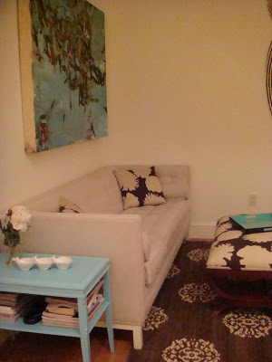 NYC loft lounge with a Jonathan Adler sofa and a turquoise side tables