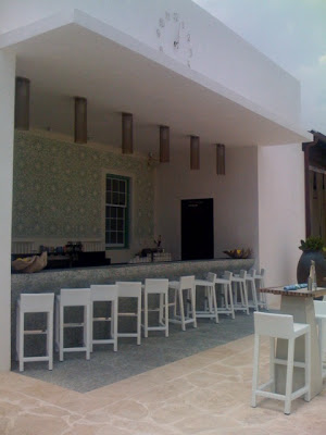 Poolside bar with modern white barstools at Alys Beach