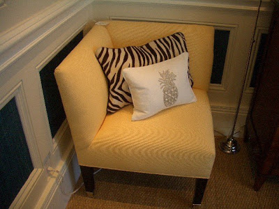 Yellow upholstered corner chair with tapered hardwood legs nickel caps from William Sonoma Home