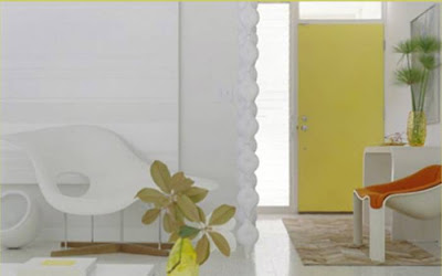 White entry hall with a bright yellow door
