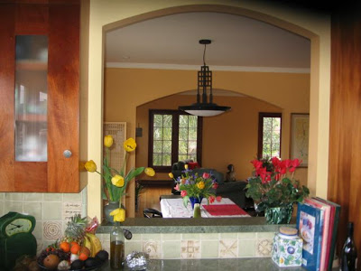 Kitchen and dining room after remodeling with an arched pass through window