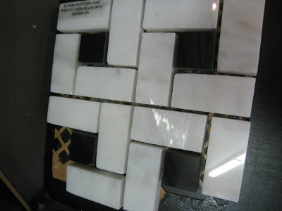 Carrara and Nero Marquina marble tiles arranged in a windmill pattern