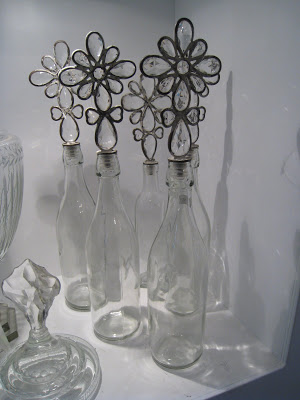 Bottles with flower shaped metal and glass stoppers from The Empty Vase