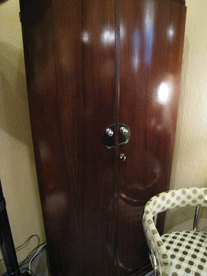 Art deco armoire with polished chrome knobs and plates