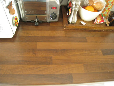 Dark brown wood butcher block counters in a small London kitchen