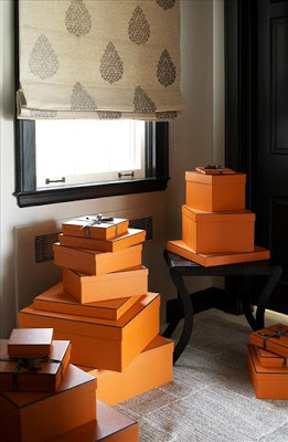 Bedroom with Orange Hermes boxes stacked under a window
