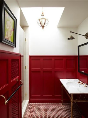 Bathroom with red and white tile floor, red paneled wainscoting and white walls