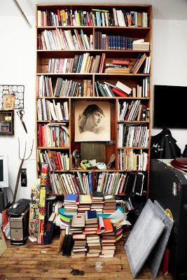 Well used wood bookshelf of a Brooklyn tattoo artist's home featured on The Selby