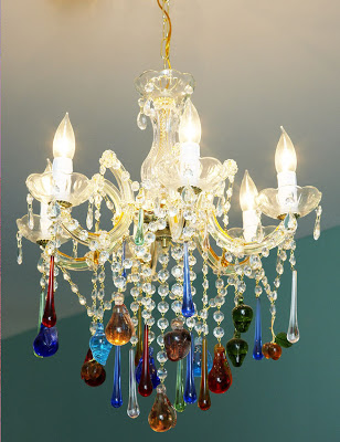 Close up of a crystal chandelier in an open kitchen, living and dining room