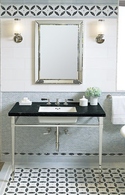 Bathroom with conrflower blue minibrick ceramic mosaic tiles from Ann Sacks on the wall, and black and white tile on the floor arranged like a rug