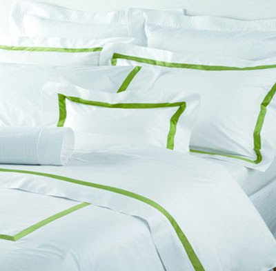 White bedding with lime green trim from Gracious Home