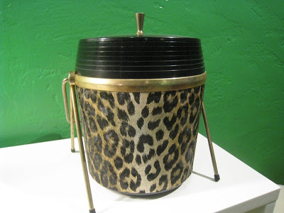 A vintage leopard print ice bucket in a Kelly Green dining room