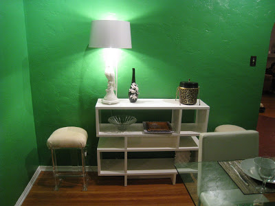 White lacquer West Elm self being used as a buffet and credenza in a Kelly Green dining room