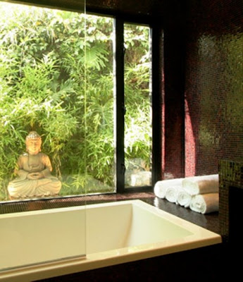 Close up of the bathtub, picture window with a view of a bamboo garden and a Buddha statue in a master bathroom after The Sunset Team/La Kaza Design's remodeling