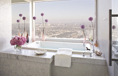 Marble bathroom by Jeff Andrews with a picture window with a view of Los Angeles