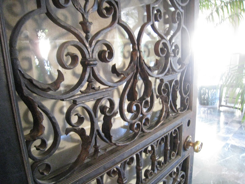 Large wrought iron scroll double doors leading to the grand entrance hall at the Greystone Mansion
