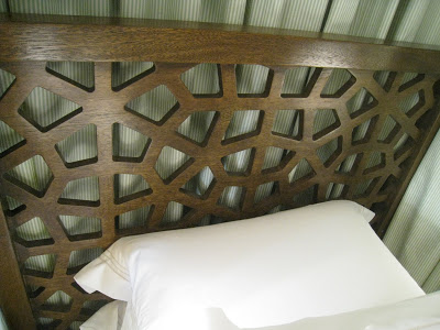 Custom dark wood modern lattice headboard in a guest bedroom in the Greystone Mansion
