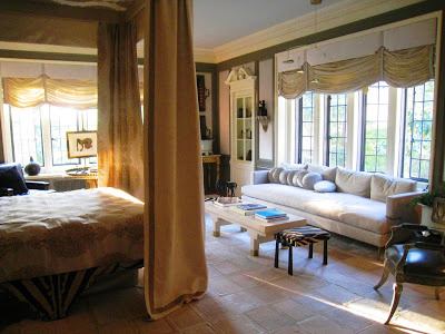 Master bedroom at the Greystone Mansion with leaded glass paned windows and large canopy bed