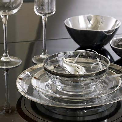 Dinnerware with clear glass plates rimmed with two striped metallic silver bands