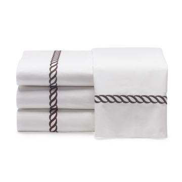 White bedding with a brown rope twist pattern from William Sonoma Home