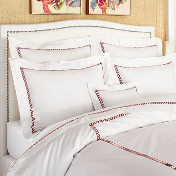 White bedding with a red rope twist pattern from William Sonoma Home