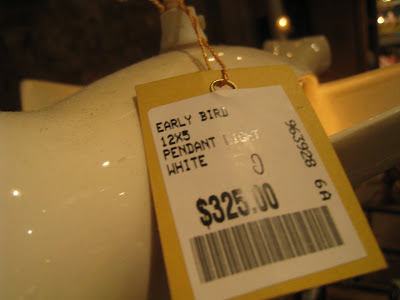 Price tag on a white ceramic bird pendant light from ABC Carpet & Home