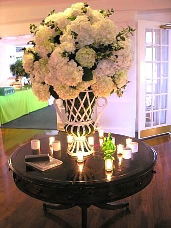 Hydrangeas for a wedding on a round dark wood table by Delaney Todd Bagwell