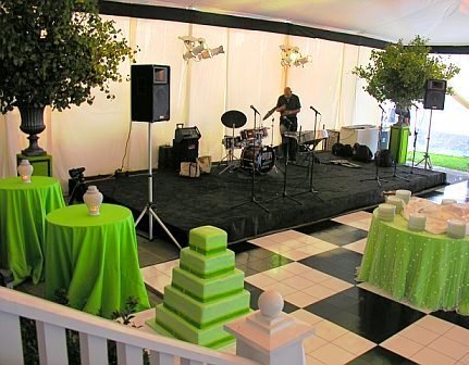 Band area at a wedding with a black and white checkered dance floor designed by Delaney Todd Bagwell