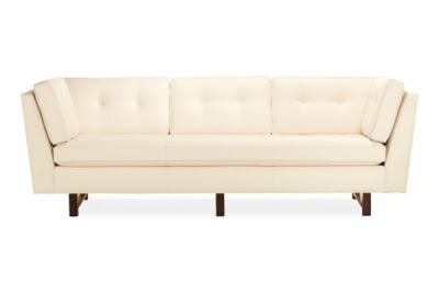 Cream sofa with Ebony stained legs, angled high arms and button tufted back pillow from Room & Board