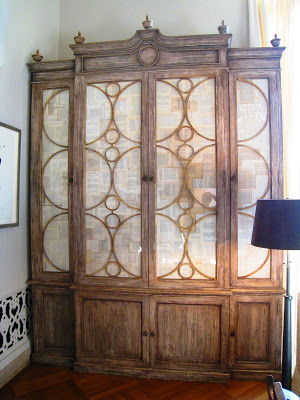Large stained wood cabinet with white linen fronts with wood circle detailing in the Grand Salon Ballroom at the Greystone Mansion