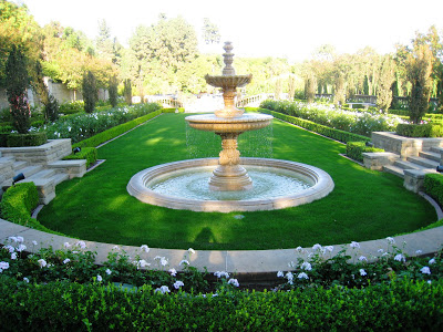 A fountain on a grassy manicured green at the Greystone Mansion in Beverly Hills, California