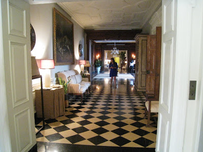Black and white checkered marble floor is laid on a diagonal in the Grand Hall of the Greystone Mansion